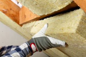 Man Installing Thermal Roof Insulation Layer